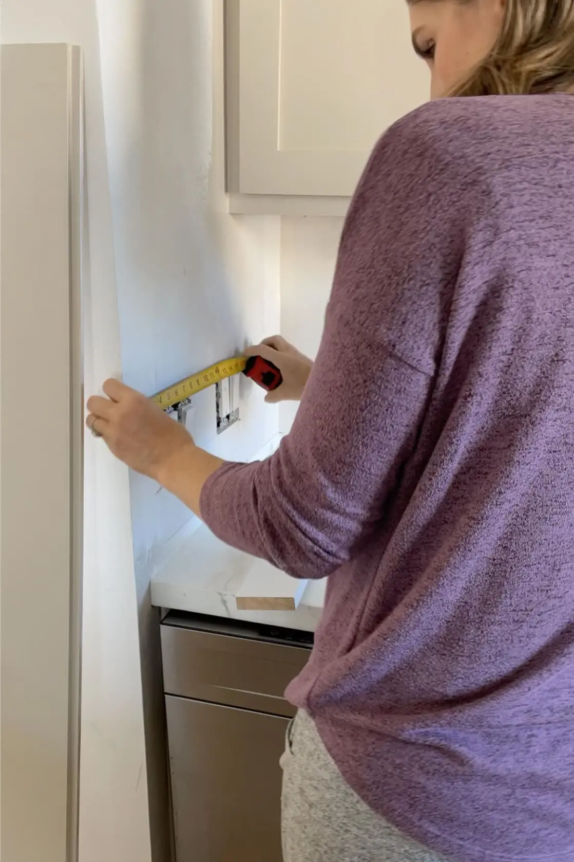 Measuring for a shiplap backsplash.